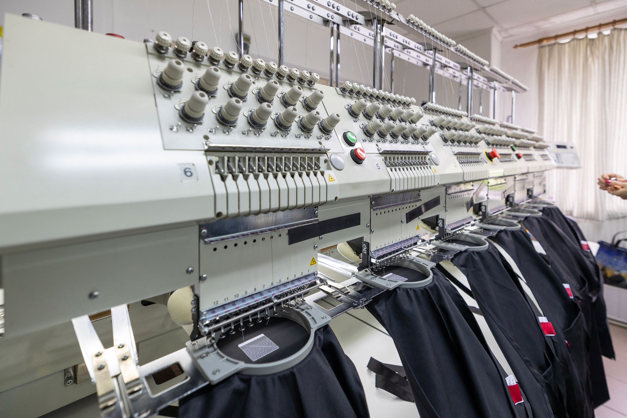 Custom embroidery machine stitching branded apparel